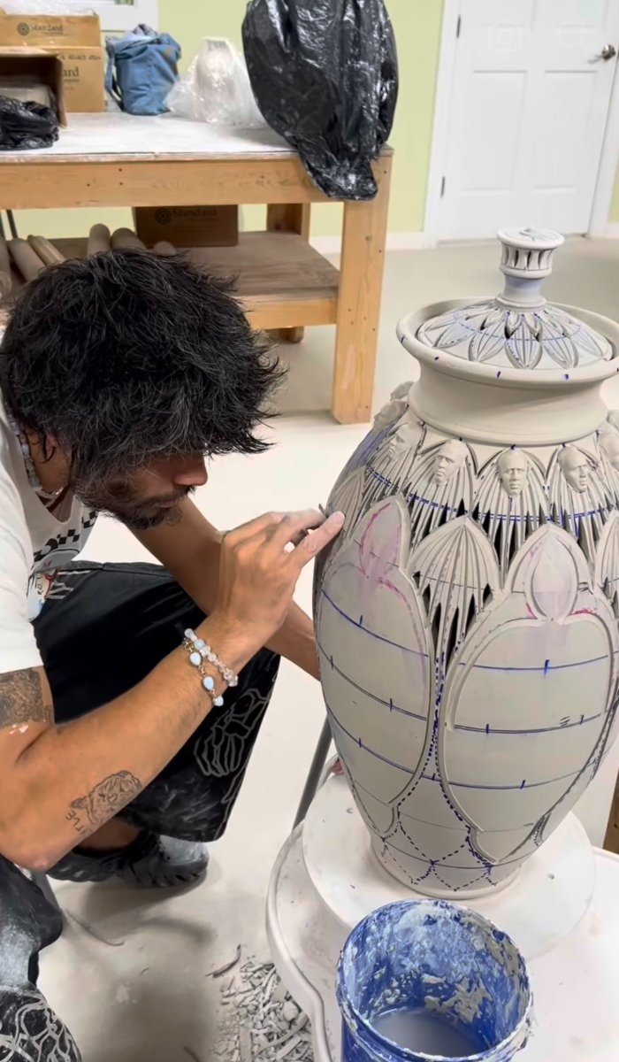 Justin Paik Reese carving a tall lidded jar in the studio
