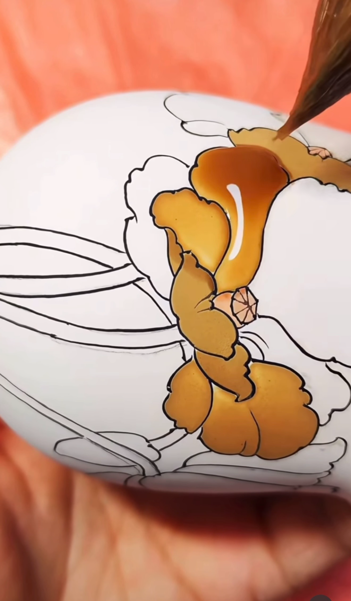 Amber overglaze pooling in a blossom outline on a rounded form