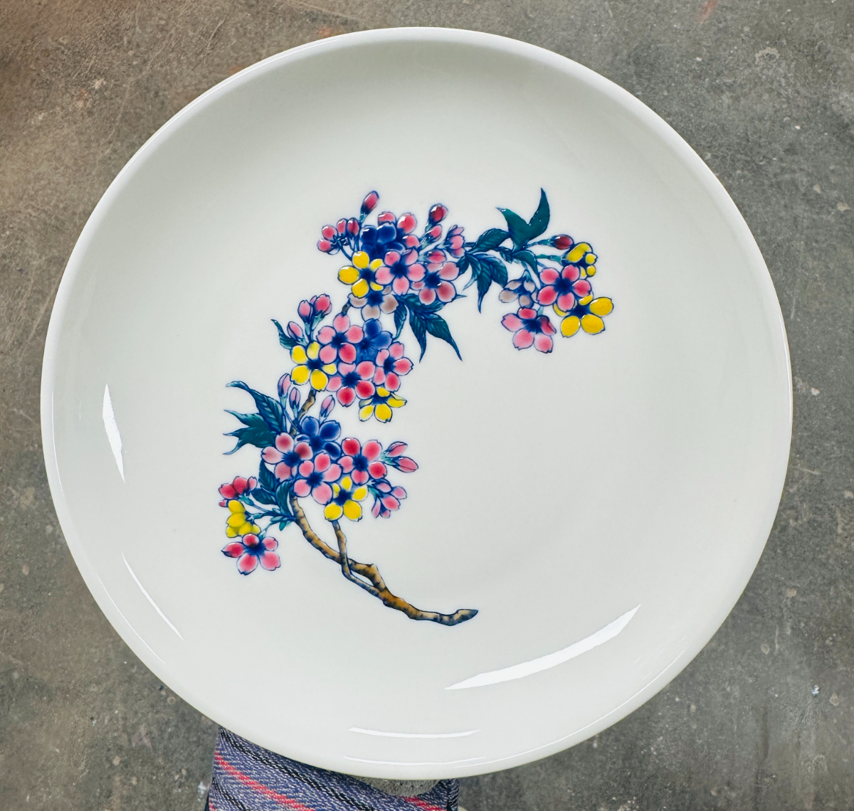 Finished cherry blossom plate in pink, blue and yellow overglaze