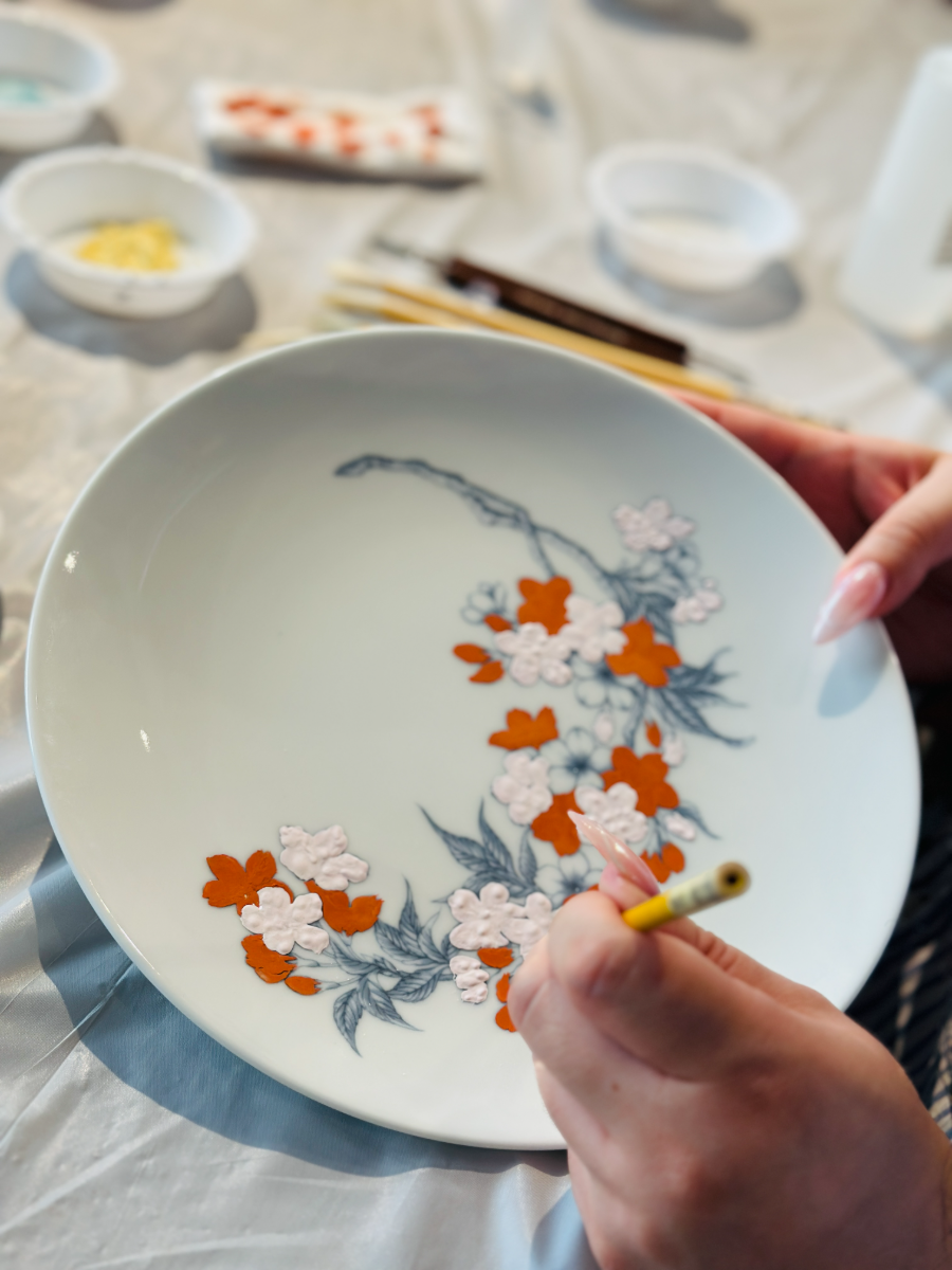 Orange and white blossoms being filled in over a grey outline